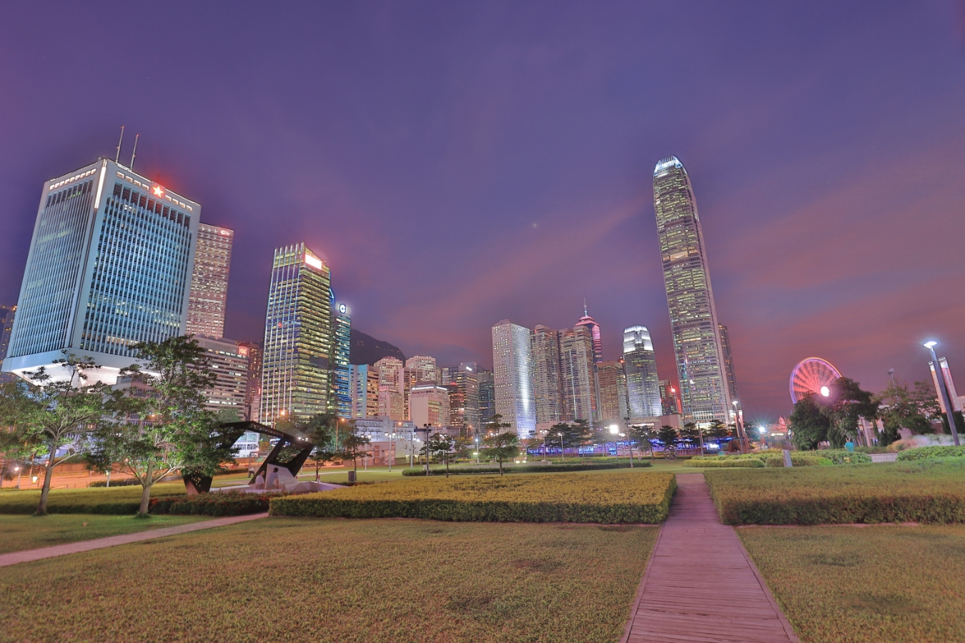 the grassy expanse at tamar park surrounded by government buildings in hong kong