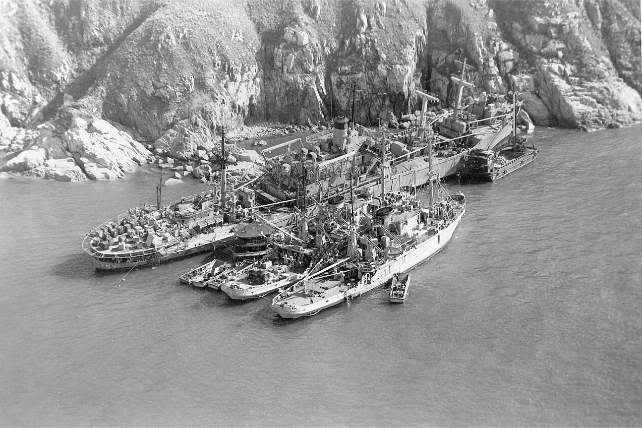 An overhead black-and-white image showing the USS Regulus run aground in Hong Kong and the salvage operations.
