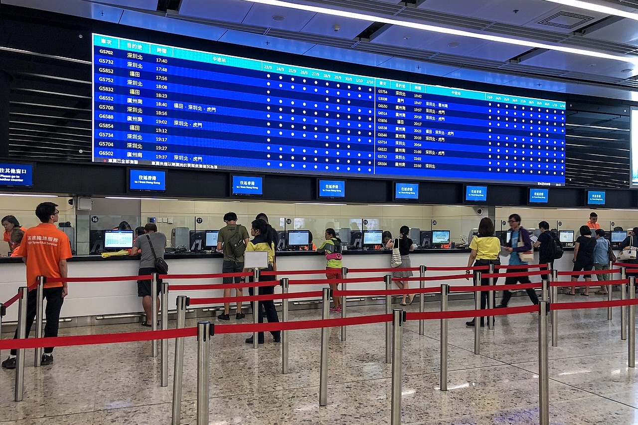 passengers lines up to buy tickets at the hong kong west kowloon station