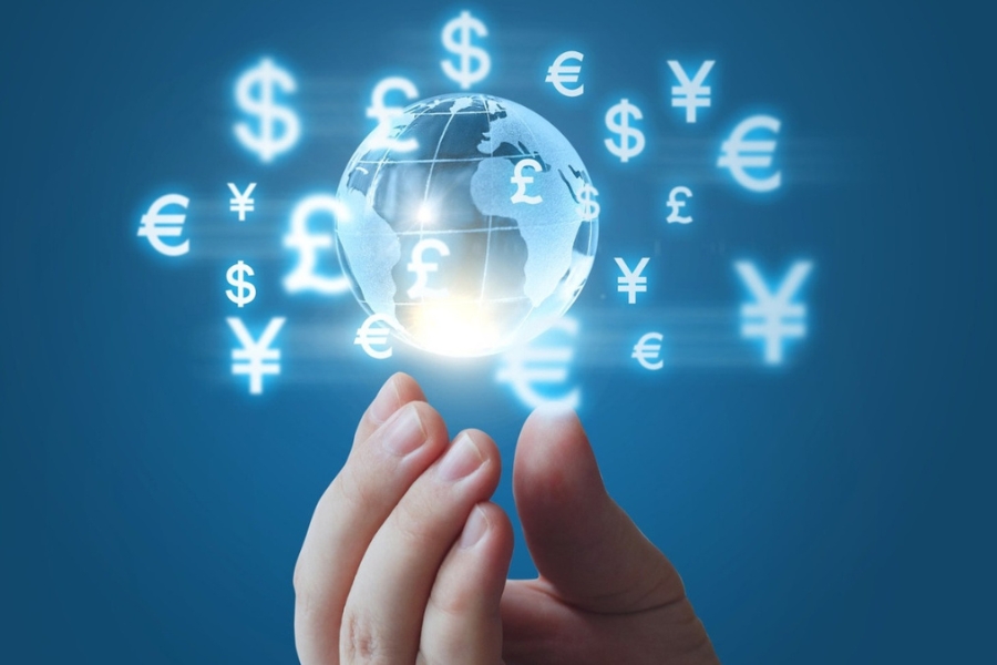 graphic showing a digital image of the world with currency signs above a person's hand
