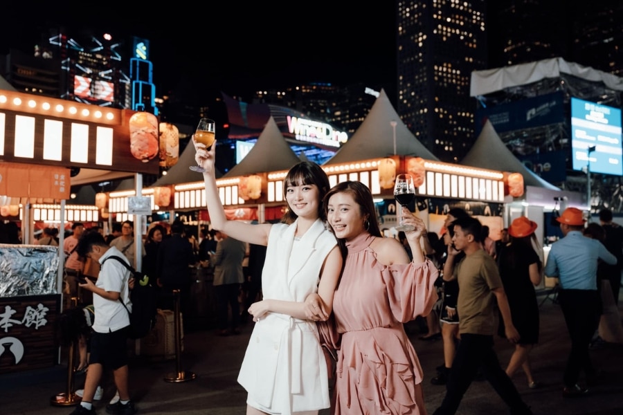 two girls holding wine glasses in wine and dine festival