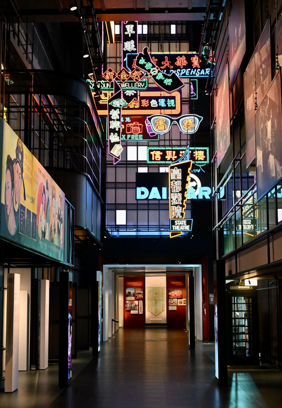 1970s Hong Kong street reconstruction with glowing neon signs and period storefront details (Hong Kong Museum of History)