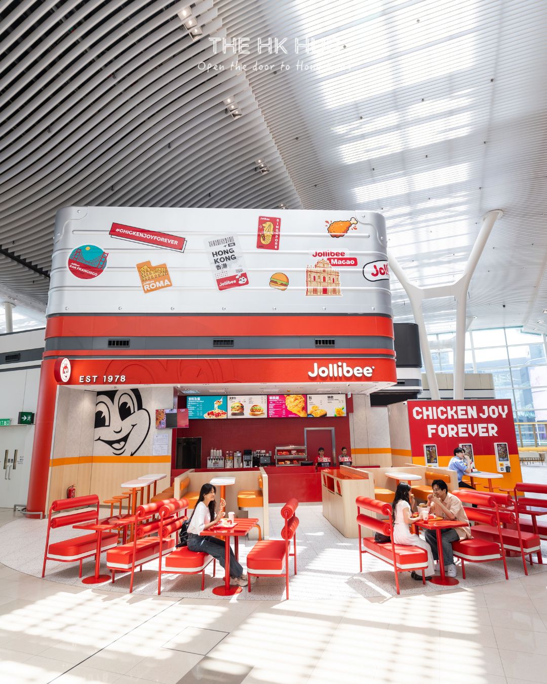 Jollibee’s suitcase-themed storefront and seating area inside HKIA Terminal 2 (Sinclair)
