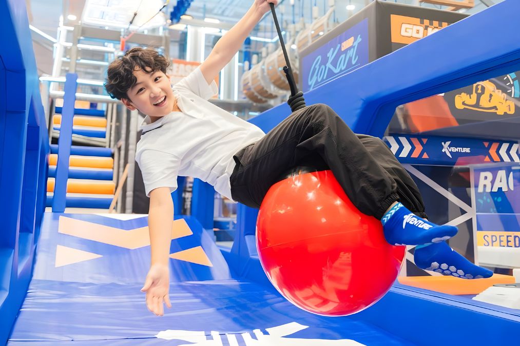 Zone 6 low zip ride using a giant ball handle across the play floor (Xventure HK)