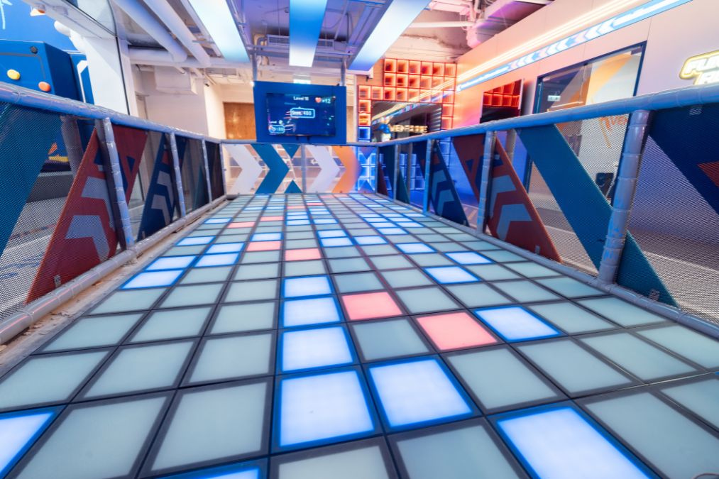 Zone 8 tech sports area with digital games, human pin wall and flashing floor squares (Xventure HK)