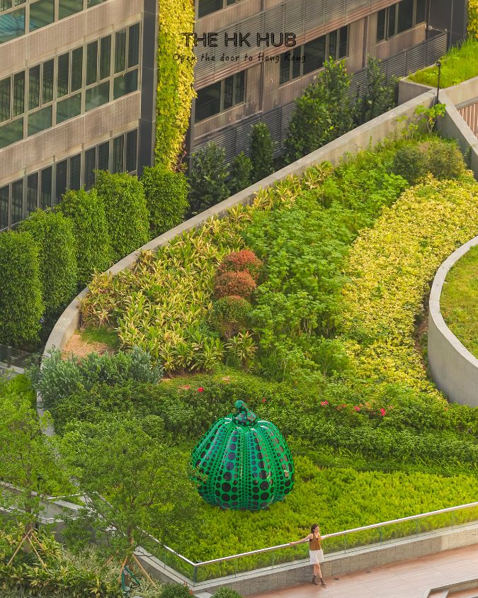 yayoi kusama green pumpkin sculpture at the twins kai tak