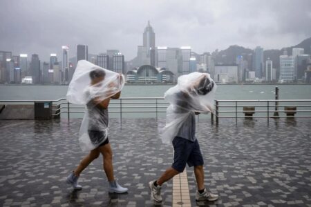 El Niño To Strengthen from October, Experts Warns Record Heat And Heavy Rain For Hong Kong 2 people on tsim sha tsui promenade during typhoon