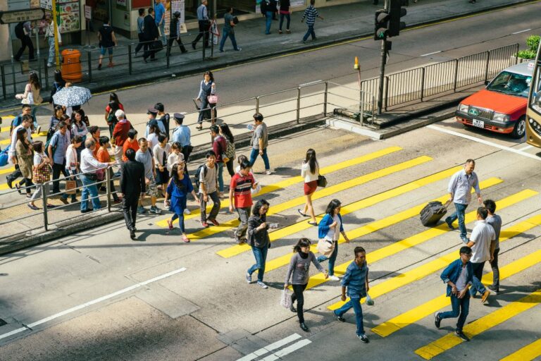 Hong Kong Now Has Nearly 7.52 Million People Despite More Deaths Than Births people crossing a road in hong kong