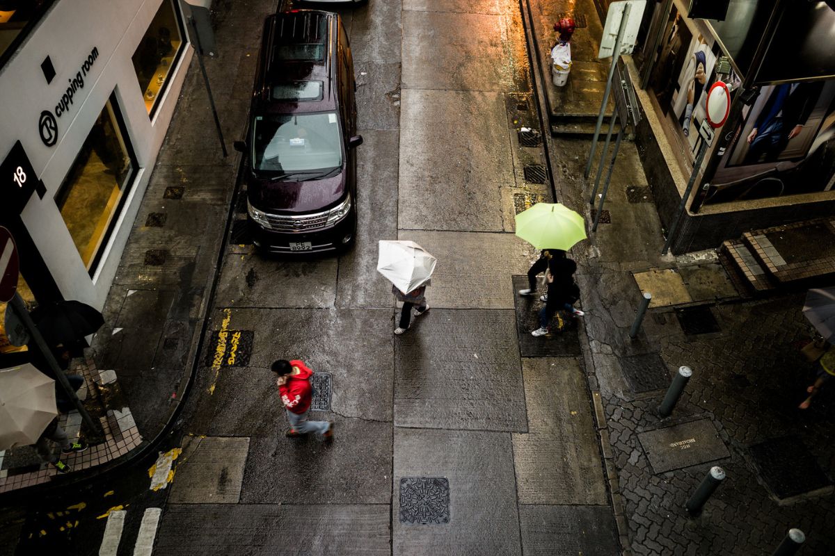 Hong Kong Braces For Wet Week As Two Tropical Cyclones Could Develop people holding umbrellas in hong kong