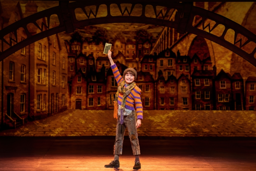 charlie bucket holding up the golden ticket