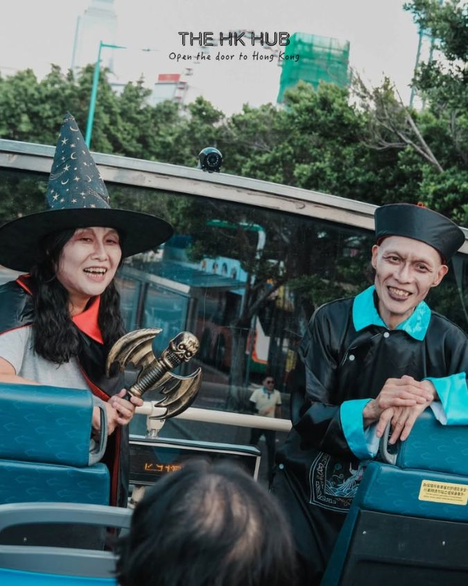 2 halloween guides telling tales to the passenger on the citybus